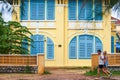 Young couple tourist walking past old french colonial building o Royalty Free Stock Photo